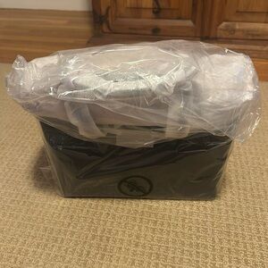 New and Unused Michael Kors Black purse with gold finishing.